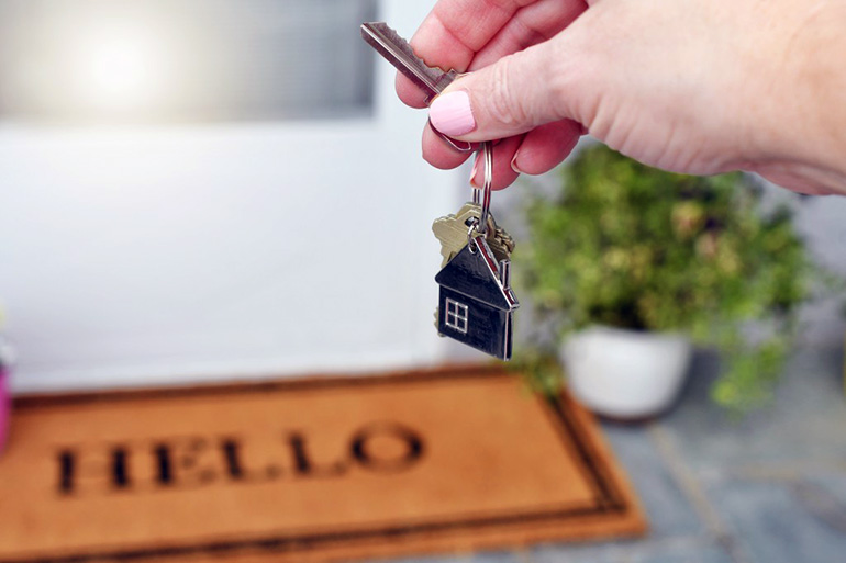 a female holding the keys of her newly inherited house