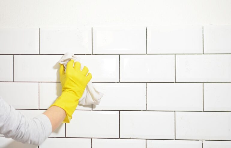 a woman cleaning wall tile