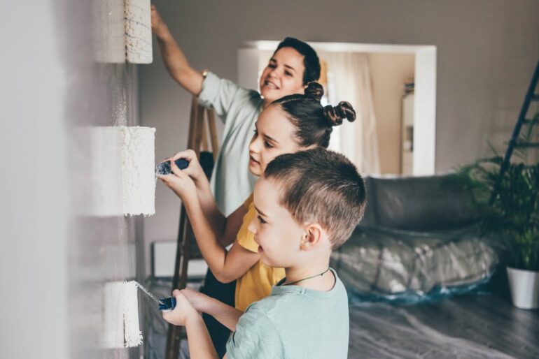 a family painting their house before selling