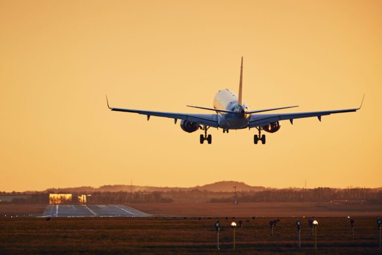 an airplane approaching a runway to land