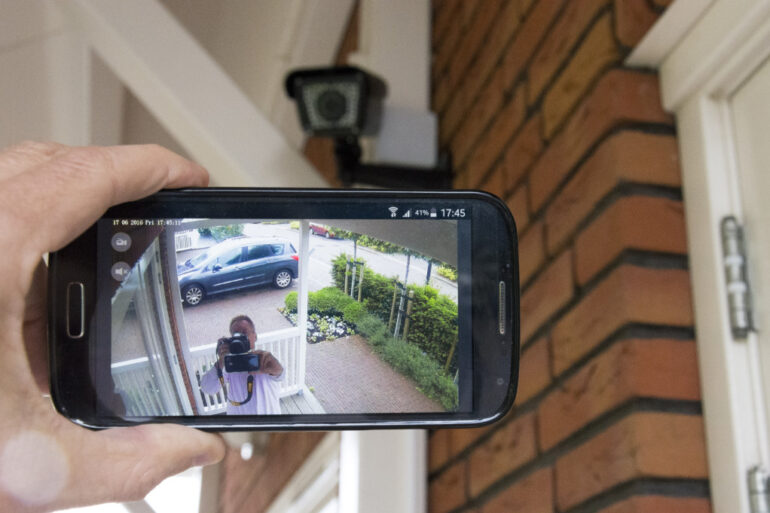 homeowner checking a wireless home security system