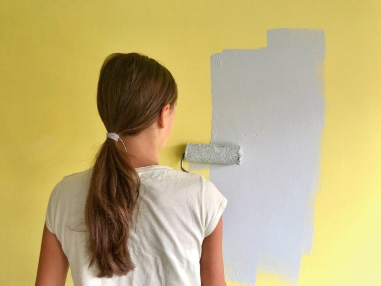 woman painting her bedroom walls